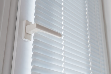 Closed window shutter blinds and handle.