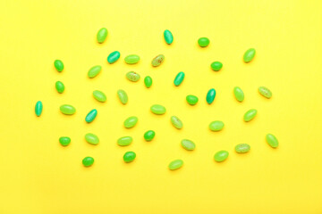 Different jelly beans on yellow background