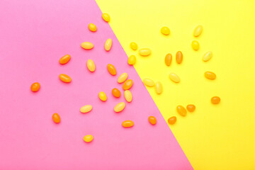Different jelly beans on color background