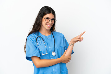 Young surgeon doctor caucasian woman isolated on white background pointing finger to the side