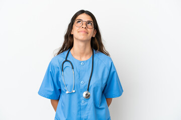 Young surgeon doctor caucasian woman isolated on white background and looking up