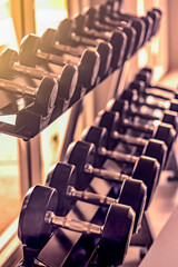 sports dumbbells in the fitness room close-up. Training is the concept of a healthy lifestyle.