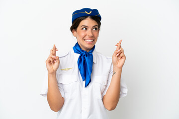 Airplane stewardess caucasian woman isolated on white background with fingers crossing