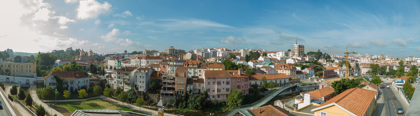 Fototapeta na wymiar Leiria, Portugal, August 29, 2021: Panoramic view of Leiria downtown cityscape with Lis River canal.