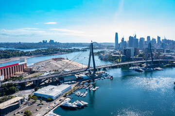 Aerial drone view of Anzac Bridge looking toward Sydney Harbour on a sunny morning  