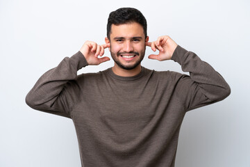Young Brazilian man isolated on white background frustrated and covering ears