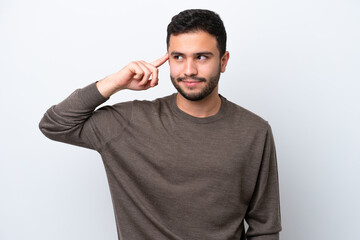 Young Brazilian man isolated on white background making the gesture of madness putting finger on the head