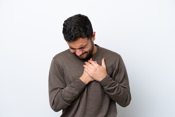 Young Brazilian man isolated on white background having a pain in the heart