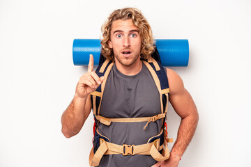 Young mountaineer caucasian man with a big backpack isolated on white background having an idea, inspiration concept.