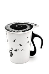 a white ceramic mug with musical notes on it and piano keyboard cover isolated on white