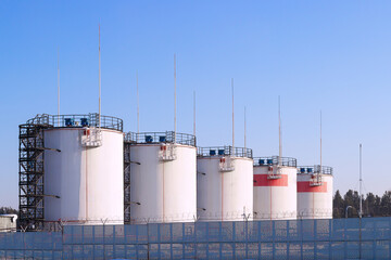 Obraz premium Row of fuel and oil storage tanks. Industrial background. 