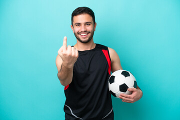 Young football player Brazilian man isolated on blue background doing coming gesture