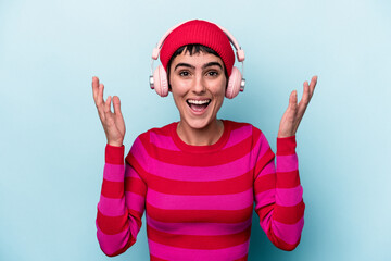 Young caucasian woman listening to music isolated on background receiving a pleasant surprise,...