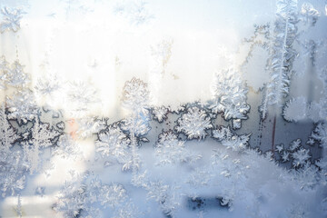 Frosty pattern on the glass of a window in a high-rise building. Winter frosts