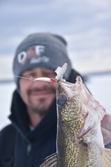 Ice angler with a walleye