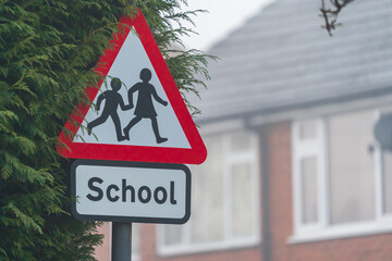 A school crossing sign on a cold misty morning