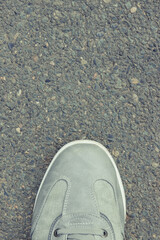 Gray leather shoes on asphalt road or footpath. Male footwear. Copy space for text