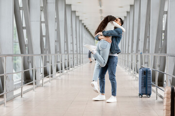 Long-Awaited Meeting. Romantic Young Arab Couple Embracing At Airport After Arrival