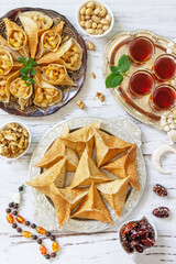 Ramadan kareem festive, fasting, halal food. Ramadan menu: assorted arabian pancake katayef and dates, pistachio. Top view flat lay.