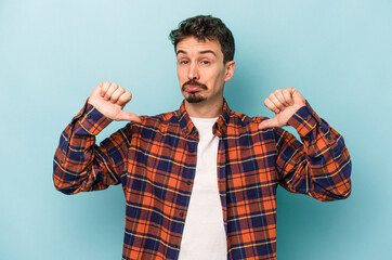 Young caucasian man isolated on blue background feels proud and self confident, example to follow.