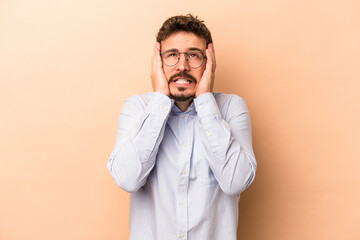 Young caucasian man isolated on beige background whining and crying disconsolately.