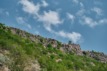 Fototapeta na wymiar Low angle photo view of huge hill and blue sky background. 