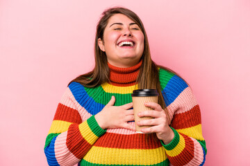 Young caucasian overweight woman holding takeaway coffee isolated on pink background laughs out...