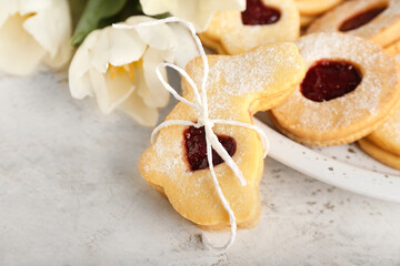 Tasty Easter cookies in shape of bunny and tulip flowers on light background, closeup