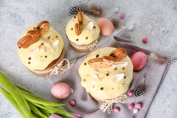 Composition with tasty Easter cakes, eggs and candies on light background