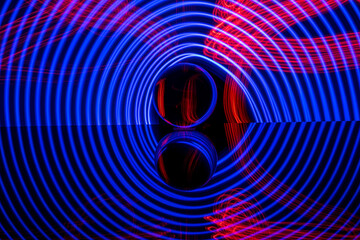 Blue glowing circles around a glass sphere with red stripes
