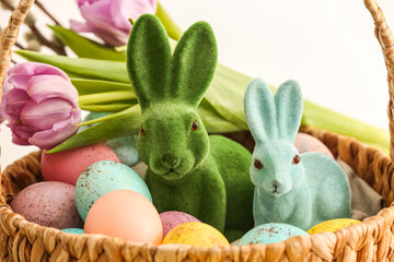 Basket with Easter eggs and bunnies, closeup