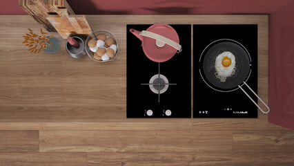 Red and wooden kitchen close up, induction and gas hob with pot and fried egg in a pan. Vase with spikes, cutting boards. Top view, plan, above with copy space, interior design