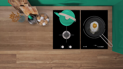 Turquoise and wooden kitchen close up, induction and gas hob with pot and fried egg in a pan. Vase with spikes, cutting boards. Top view, plan, above with copy space, interior design