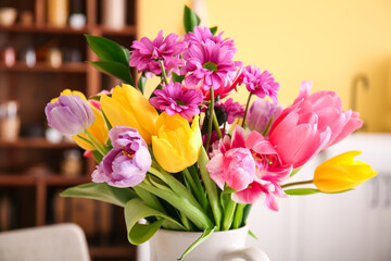 Bouquet of beautiful flowers in kitchen, closeup