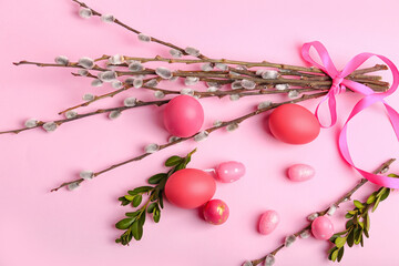 Painted Easter eggs and pussy willow branches on pink background