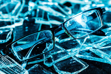 glasses on shards of glass. blue toning
