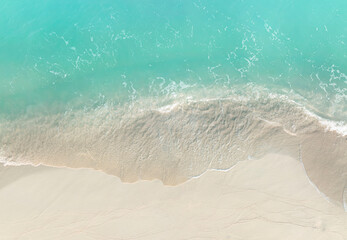 Turquoise color of  wave water background on the summer beach at the seashore and  white  sand...