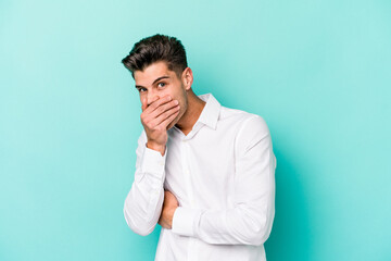 Young caucasian man isolated on blue background scared and afraid.