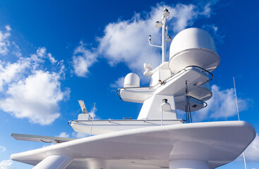 The mast of a large yacht with navigation equipment bottom view. Radar, signal lights, satellite...