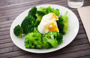 diet food. steamed broccoli with boiled egg on plate