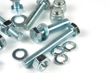 metal bolts and nuts with round washers close-up on a white background. copy space
