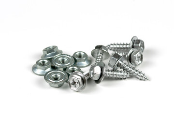 metal bolts and nuts with round washers close-up on a white background