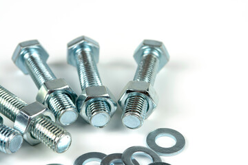 metal bolts and nuts with round washers close-up on a white background