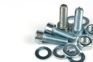 metal bolts and nuts with round washers close-up on a white background. copy space