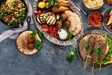 Arabic food assortment on dark background.