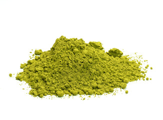 Close-up view of a heap of matcha tea powder on white background