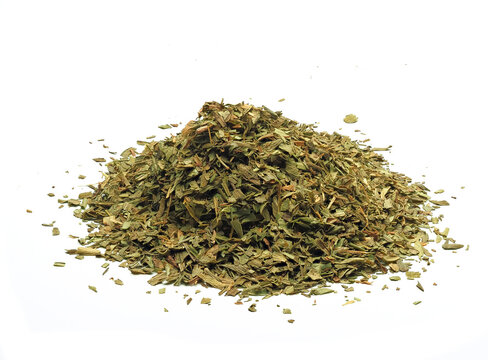 Close-up view of a heap of dried tarragon on white background