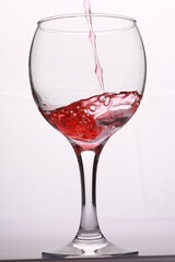 red wine pours into the glass
