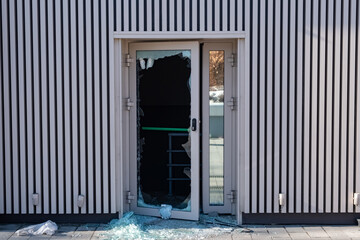 Broken glass door in shopping mall. Vandalism, burglary concept. Insurance concept.