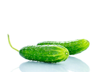 Two ripe green cucumbers, macro, isolated on white background.